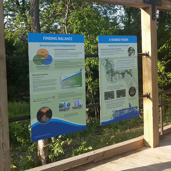 Upright rail installation of interpretive signs on boardwalk along Minnehaha Creek